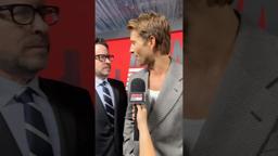 JJ Abrams surprises Glen Powell on The Running Man red carpet.